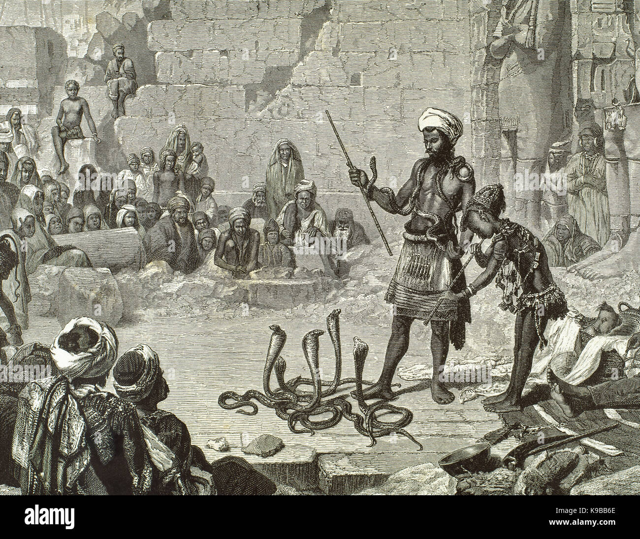 Egypt. Snake charming by playing a bansuri in the second courtyard of Medinet Habu. Engraving. 19th century. Stock Photo