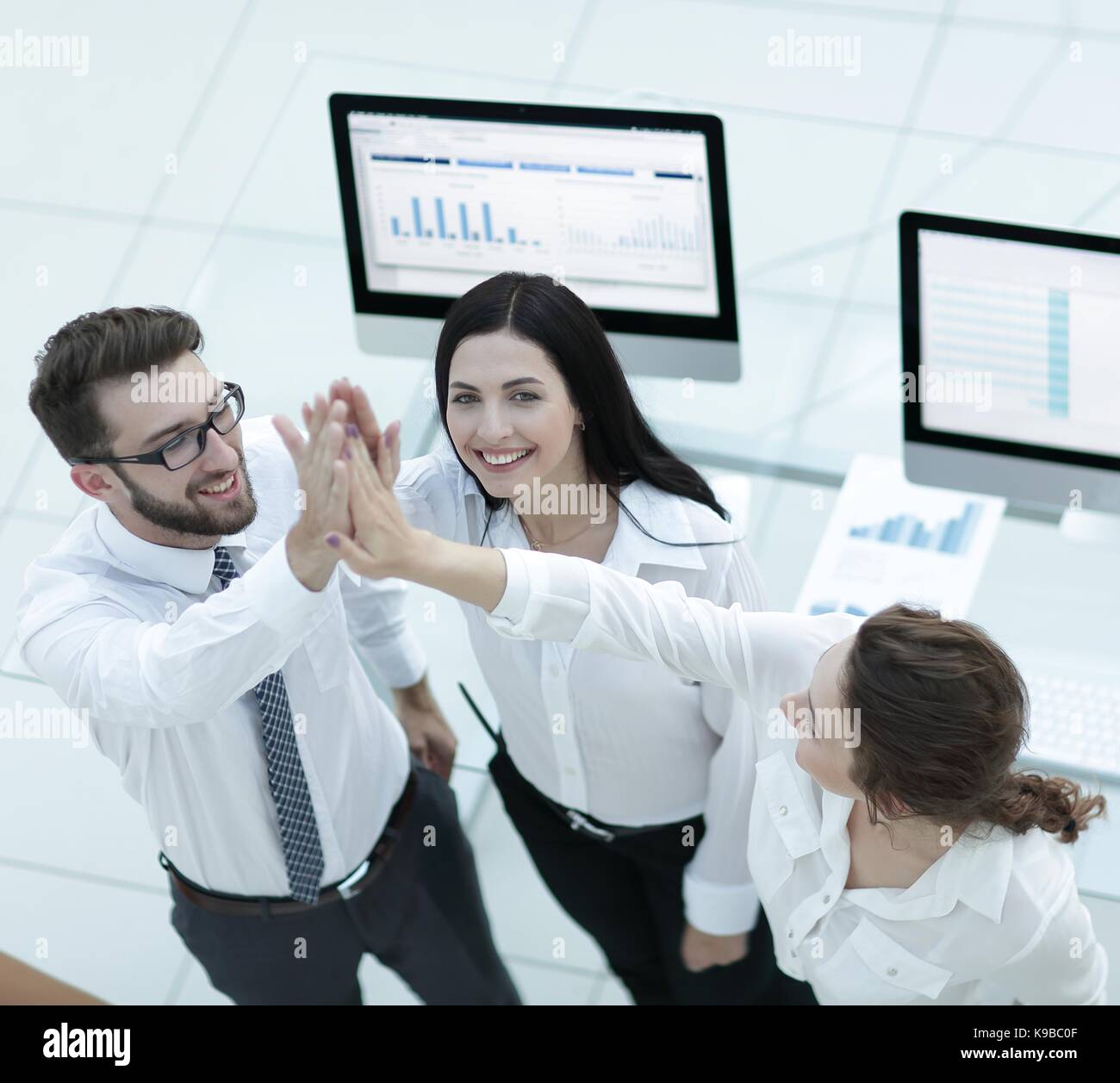 successful business team giving each other a high five Stock Photo - Alamy