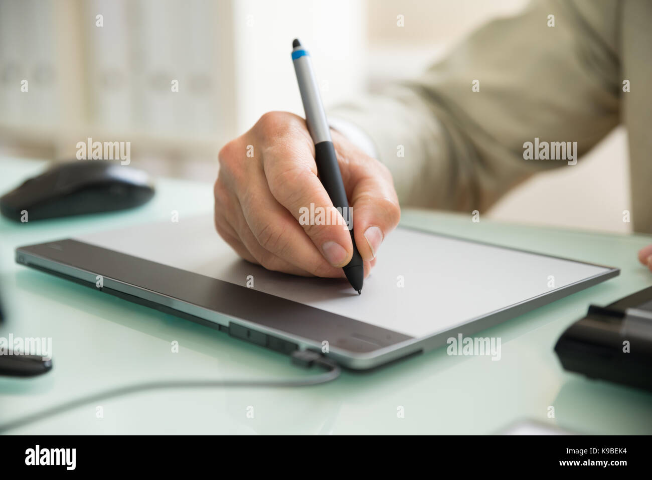 Close-up Of A Businessman Using Graphic Tablet In Office Stock Photo