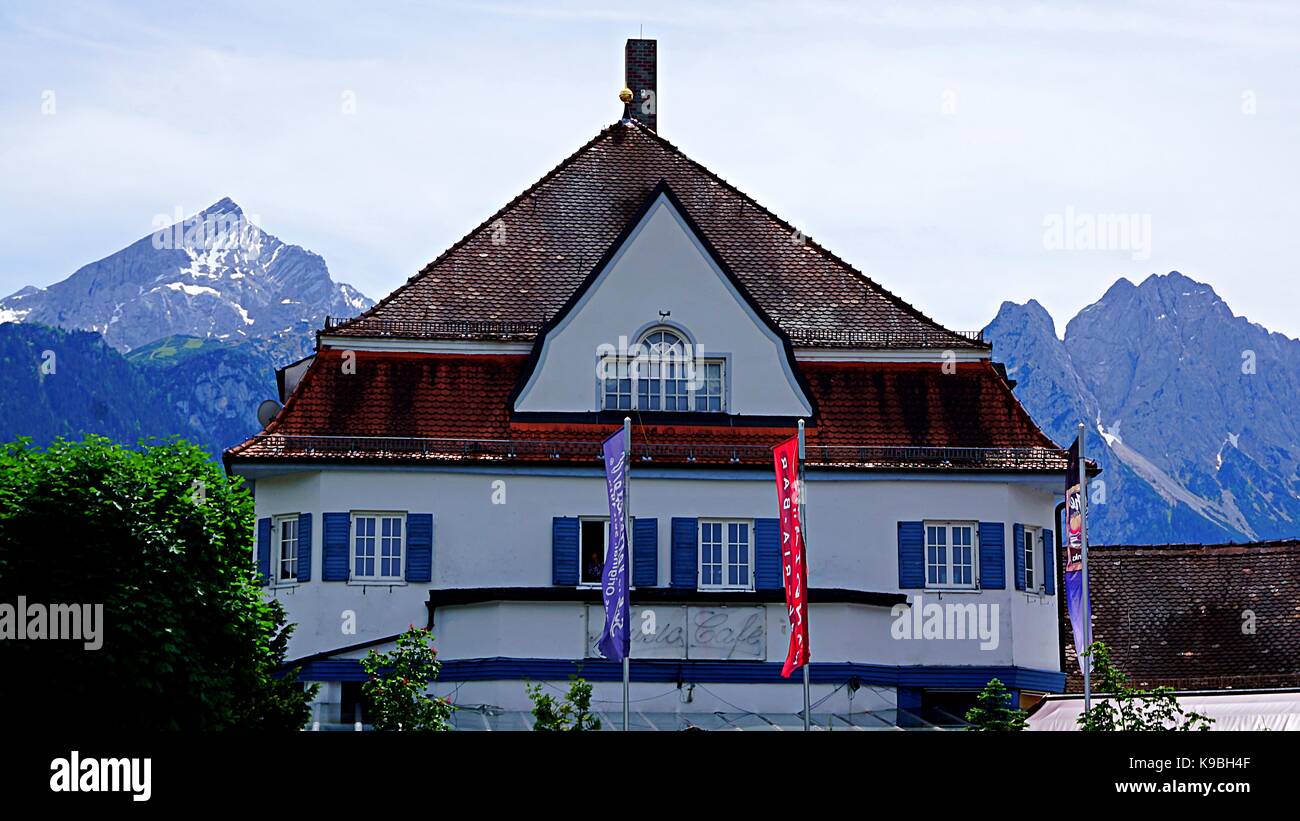 A building with mountains behind in Garmisch-Partenkirchen, Germany Stock Photo