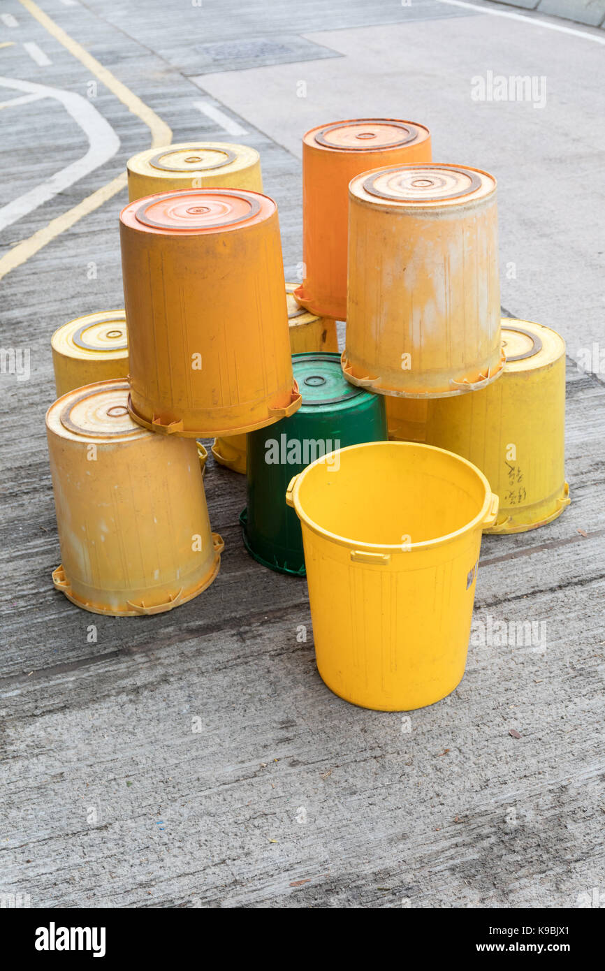 Bunch of Yellow Buckets at Street in Hong Kong Stock Photo