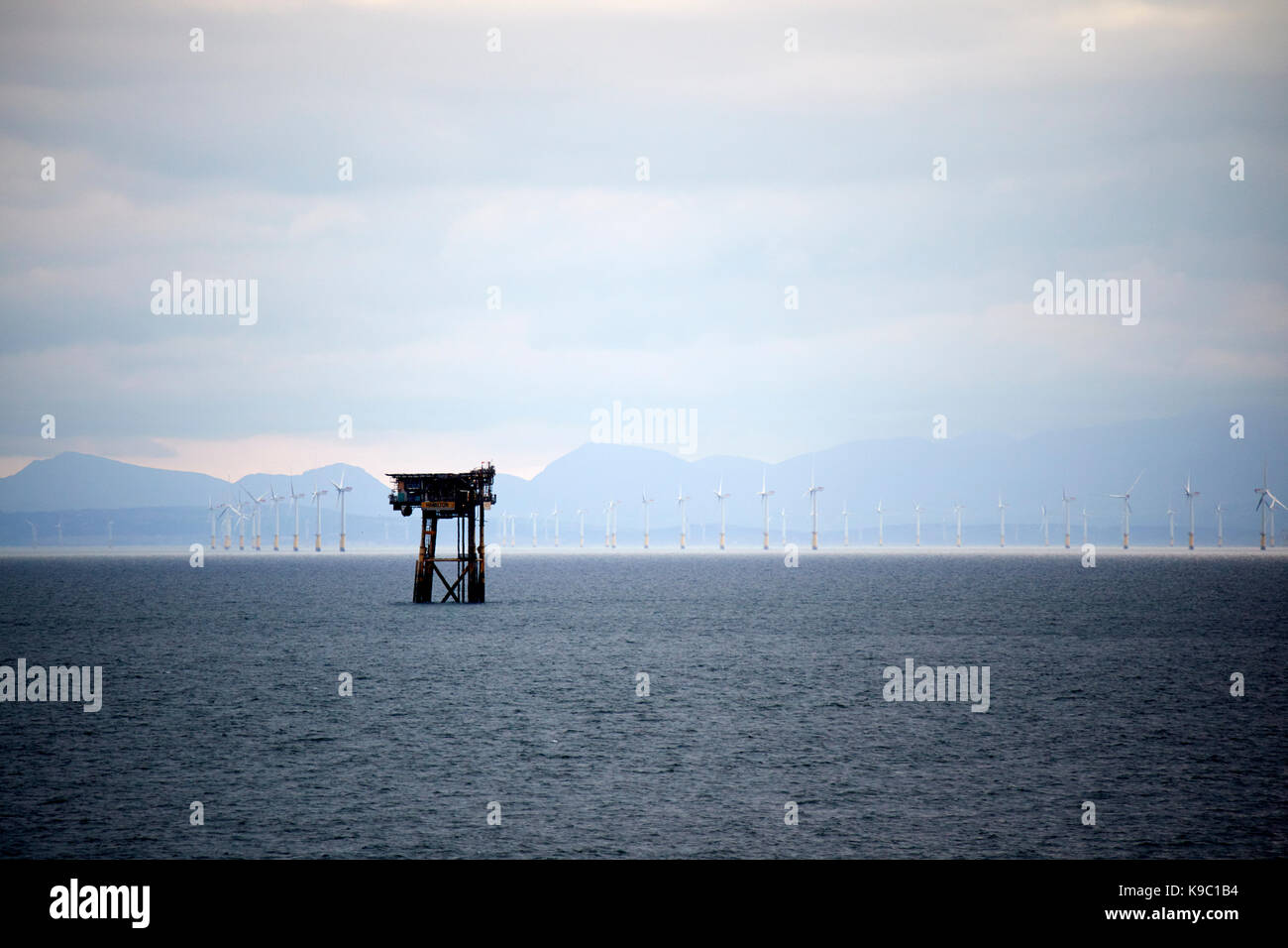 hamilton unmanned satellite platform part of the douglas oil complex in the irish sea in front of north hoyle offshore wind farm north wales Stock Photo