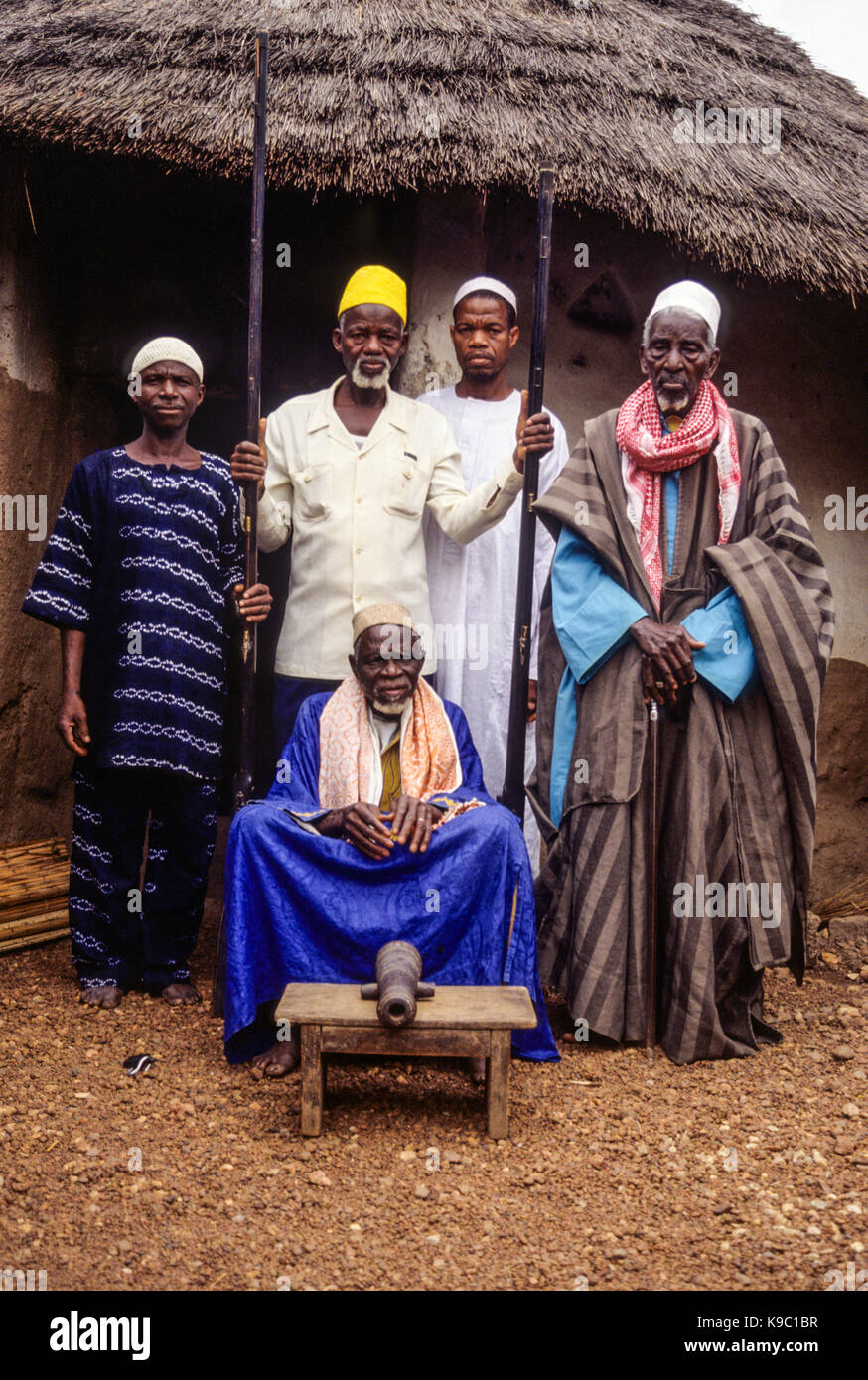 Samatiguila, Ivory Coast, Cote d'Ivoire.  Village Muslim Elders with one of the Weapons of Samori Toure, who resisted French Incursions in the late 19th. Century. Stock Photo