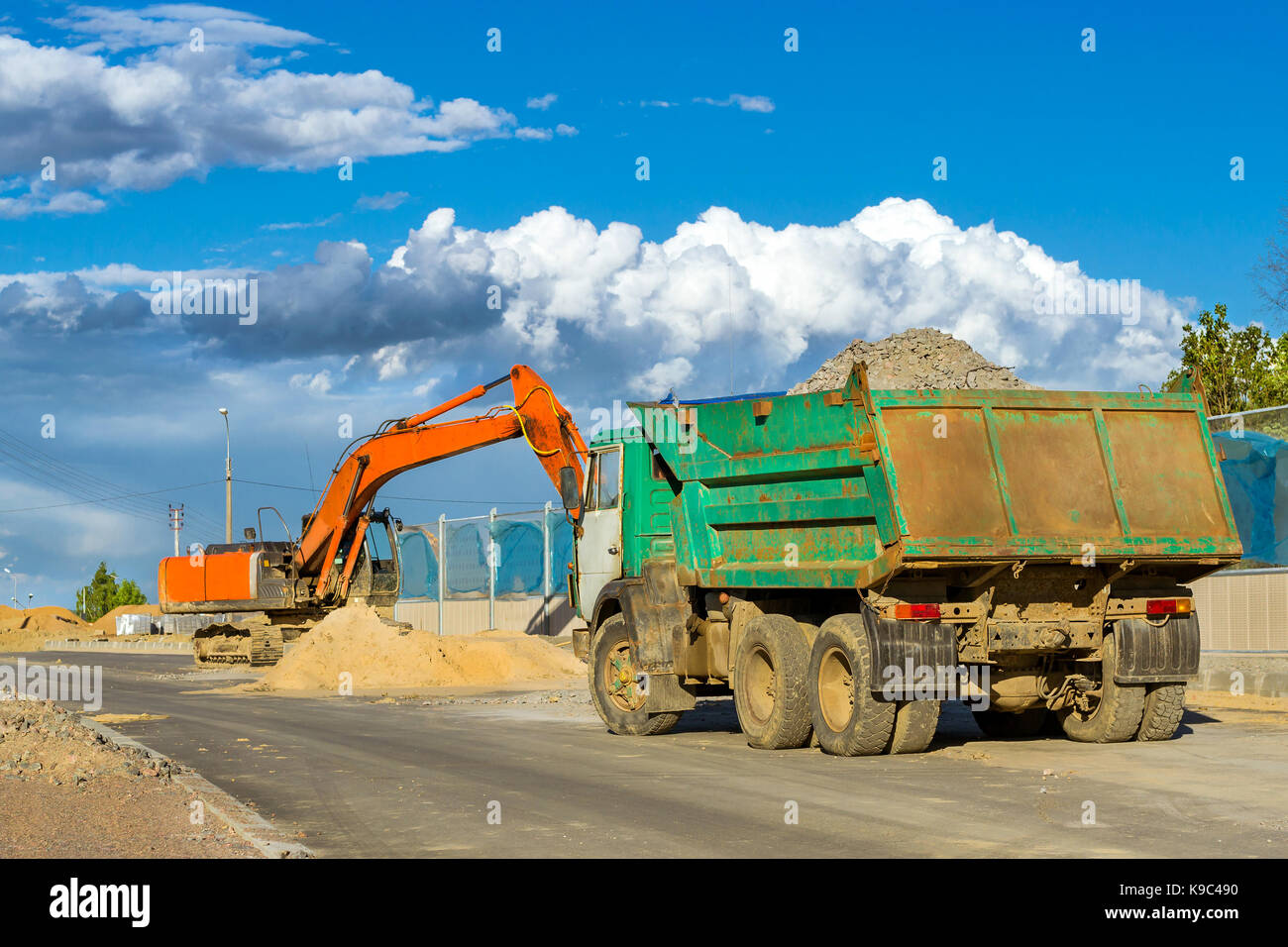 Crawler Excavator digging bucket on construction of high-speed bypass road. Working truck with body. Heavy machine equipment for excavation works at c Stock Photo