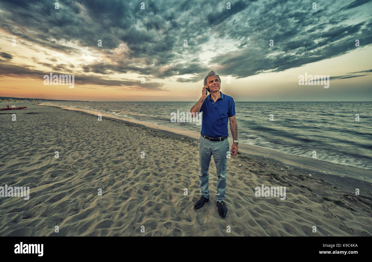 Elderly man walking phone hi-res stock photography and images - Alamy