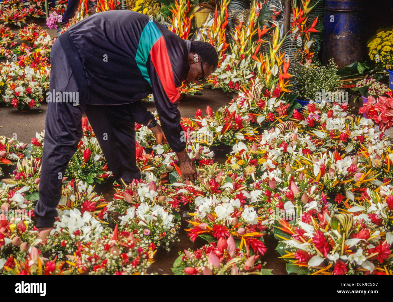 Abidjan, Ivory Coast, Cote d'Ivoire.   Fixing Bouquets of Flowers in the Cocody Market. Stock Photo