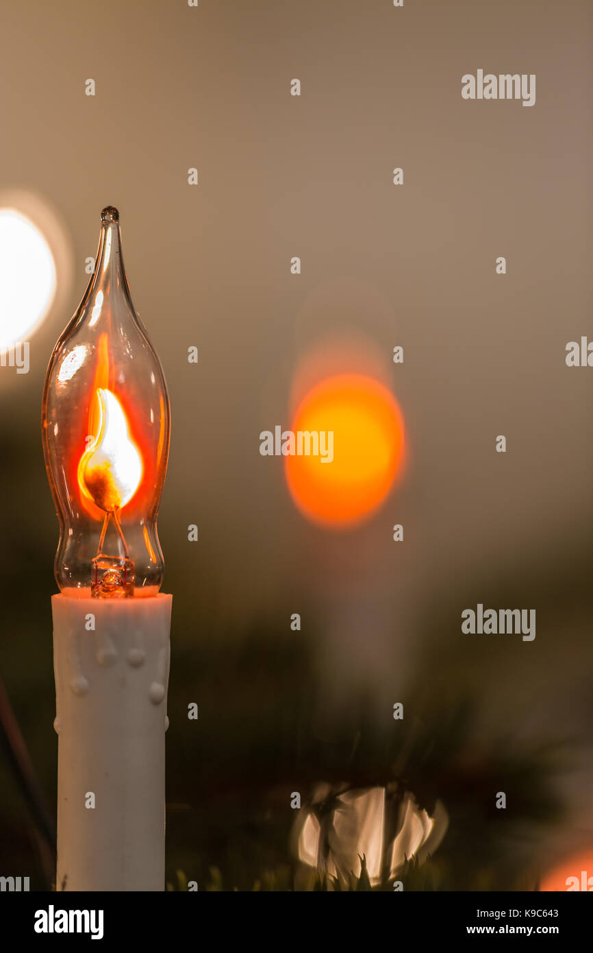 New Year's electric candle on spruce tree branch Stock Photo Alamy