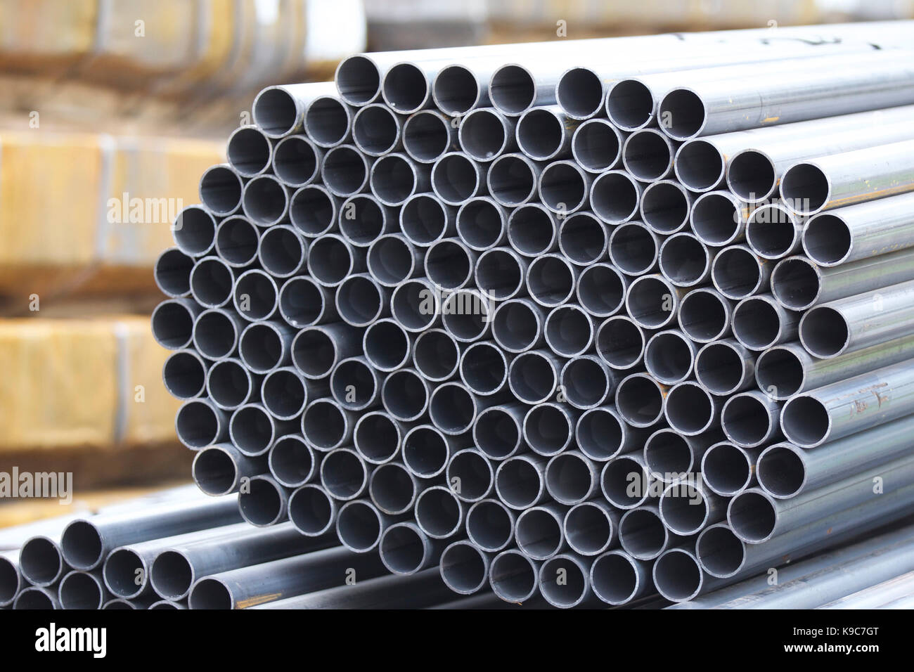 Metal profile pipe of round section in packs at the warehouse of metal ...