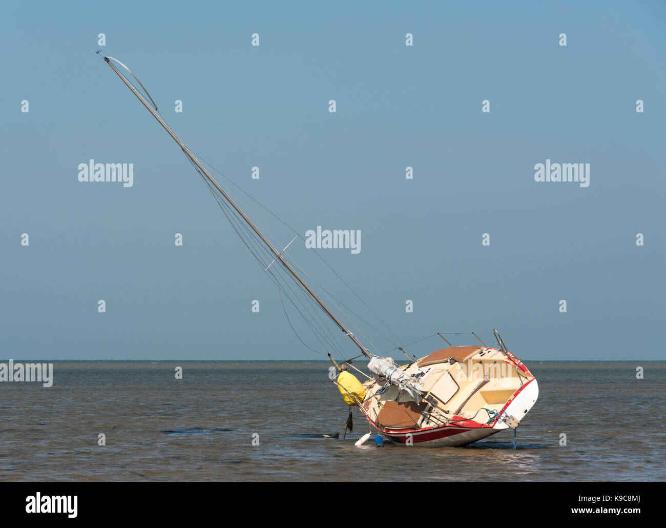 Sailing boat at low tide resting on its side Stock Photo