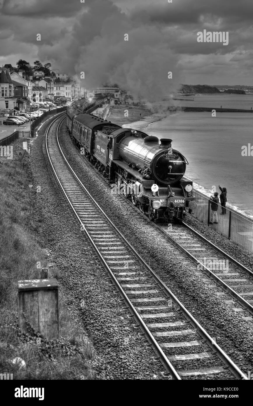 Waving to the steam train at Dawlish. The Cathedrals Express to Kingswear, hauled by LNER Class B1 No 61306 Mayflower. (Processed as an HDR image.) Stock Photo