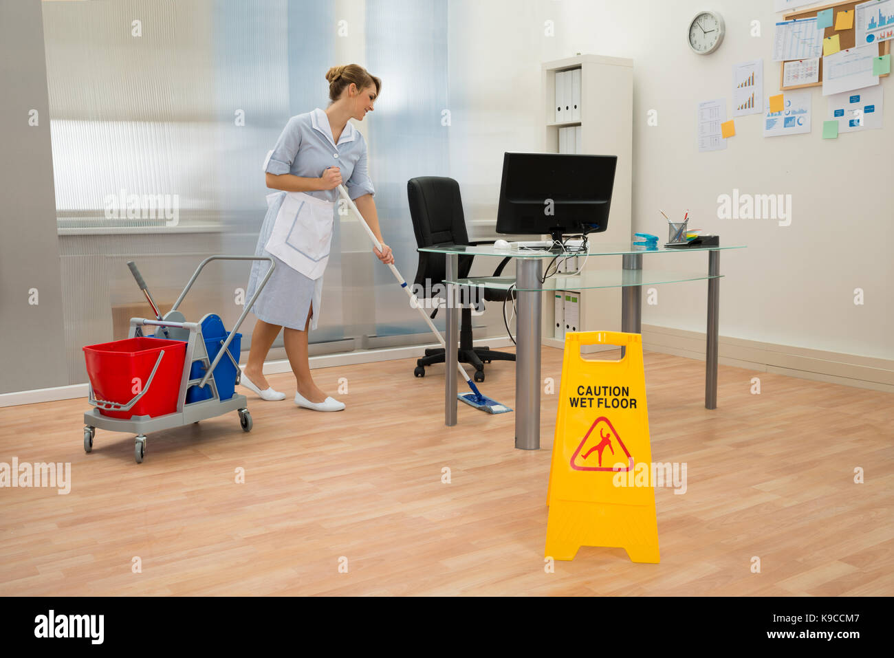 Young Maid Cleaning Floor With Mop In Office Stock Photo Alamy