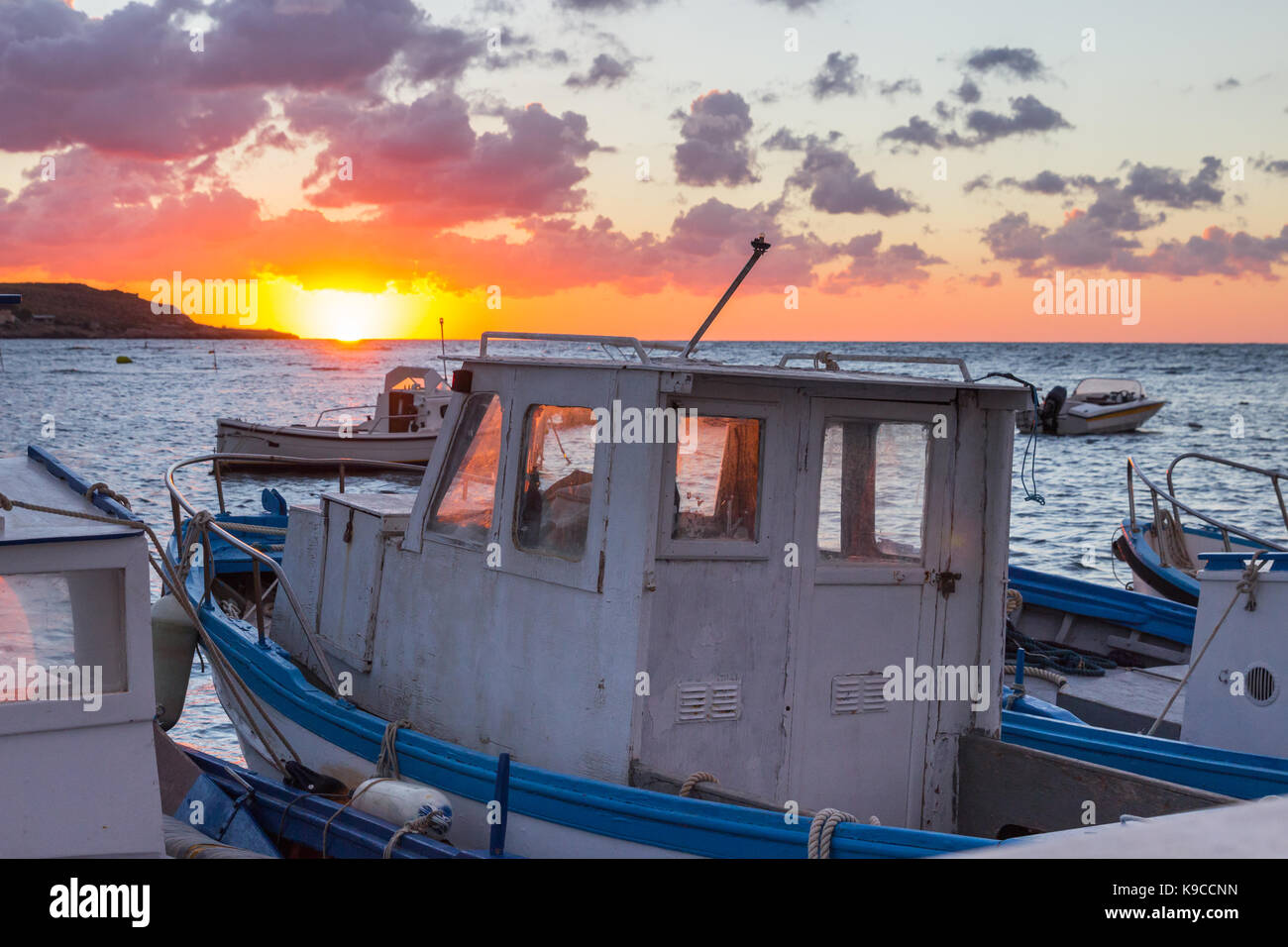 Sunset sea port row boat fishing sun Stock Photo