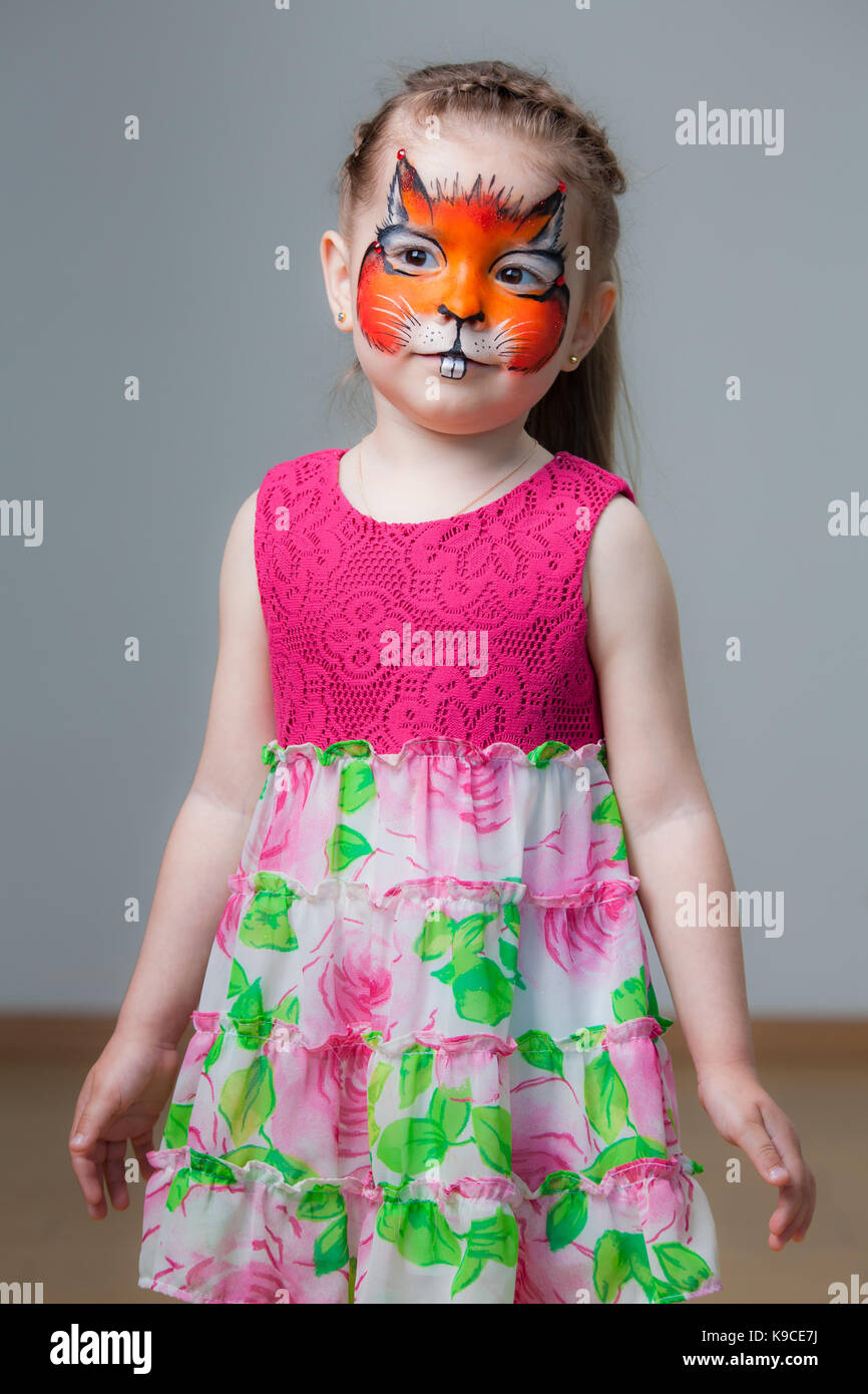 A girl paint mascot on her face.