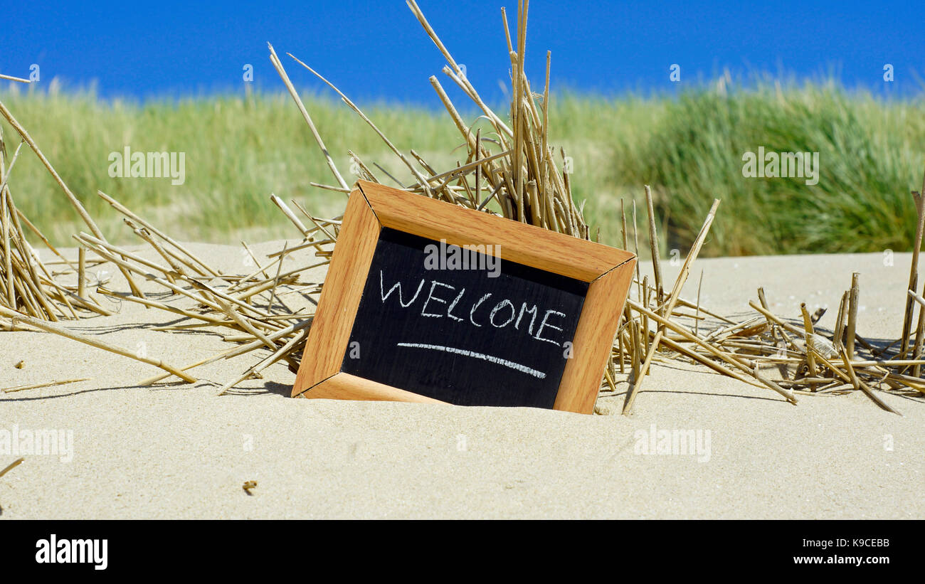 Welcome written on a chalkboard at the beach in the summer Stock Photo ...