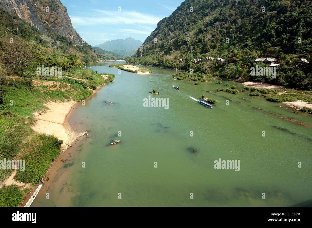 Two passenger boats make their way through a mountain ravine on the Nam Ou river to Nong Khiaw in north east Laos Stock Photo
