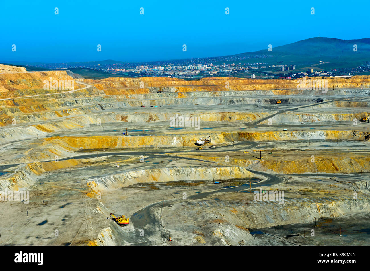 Benches of an open-pit copper mine of the Erdenet Mining Corporation EMC, city of Erdenet behind, Erdenet, Mongolia Stock Photo