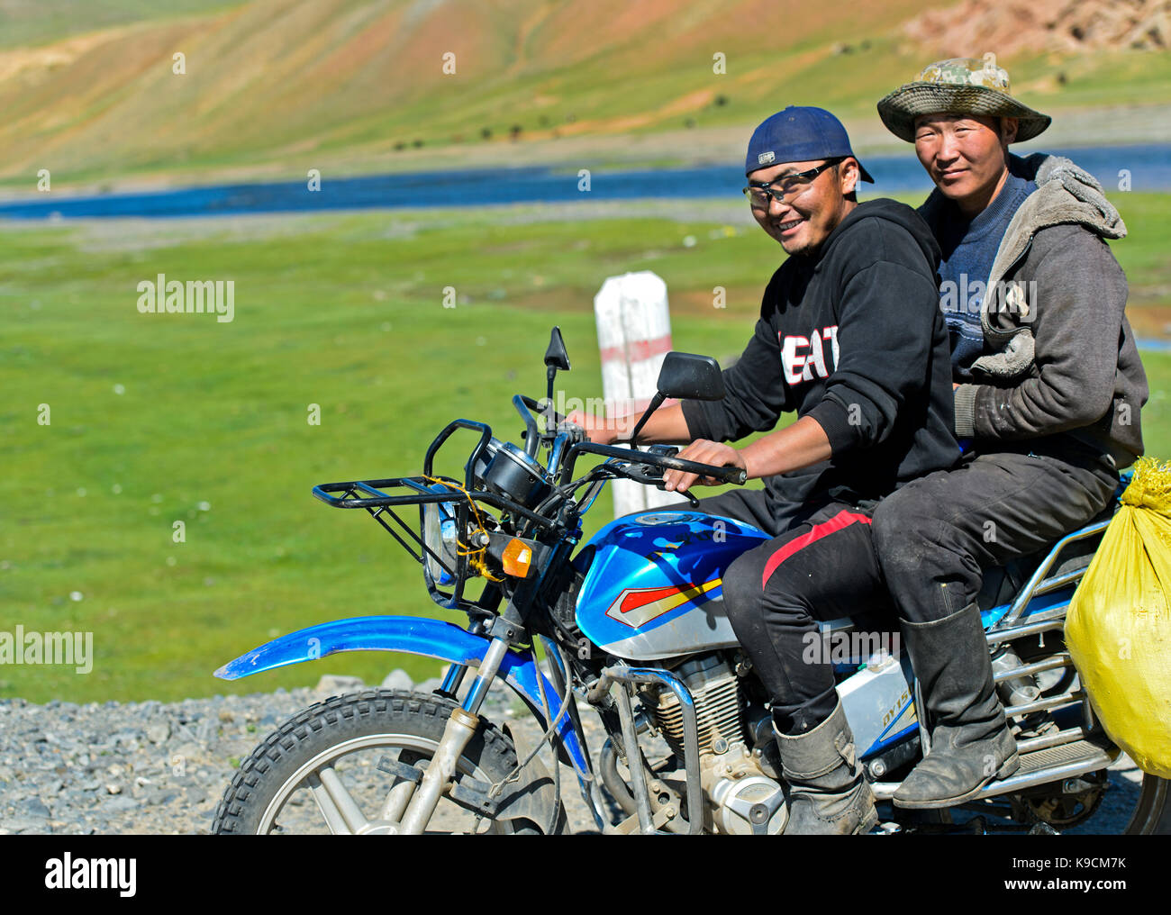 Two local men driving on a motor-bike, Orkhon Valley, Khangai Nuruu National Park, Oevoerkhangai Aimag province, Mongolia Stock Photo