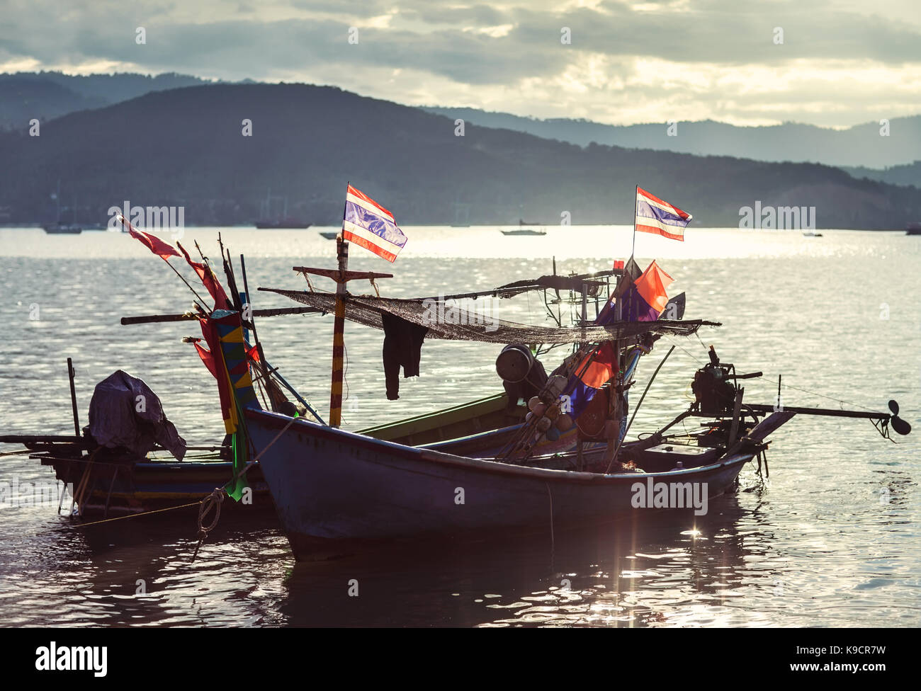 fishing boat in the sea at sunset in Thailand Stock Photo - Alamy