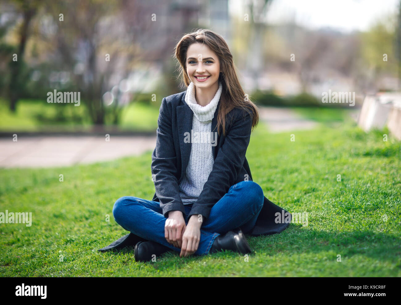 Beautiful smiling woman sitting on a grass outdoor. relax concept Stock ...