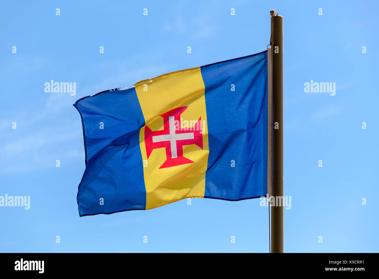 Flag of Madeira. Blue-gold-blue vertical triband with a red-bordered white Cross of Christ in the center Stock Photo