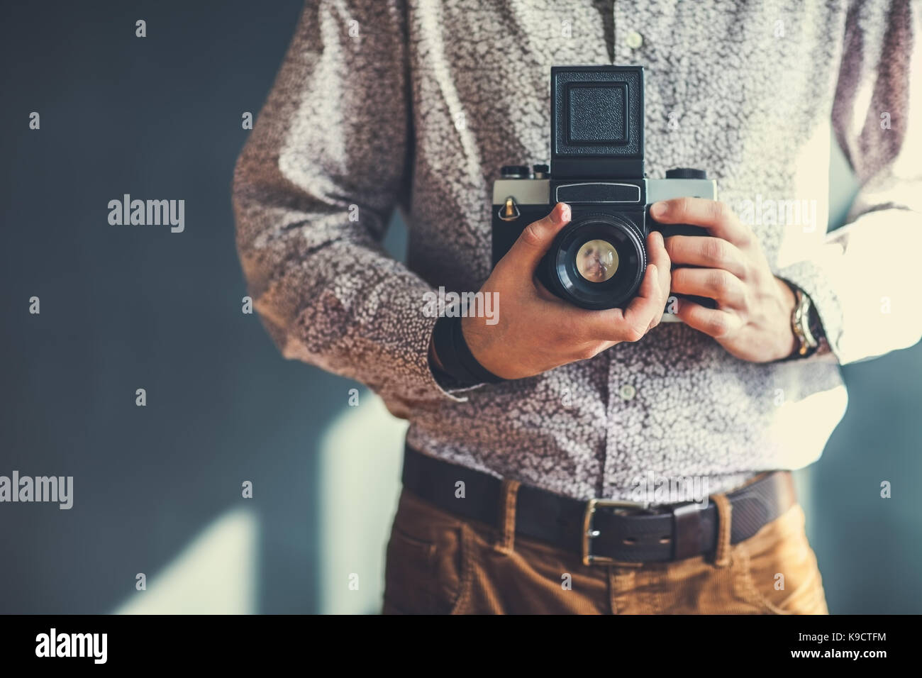 old medium format camera in photographer hands in studio Stock Photo