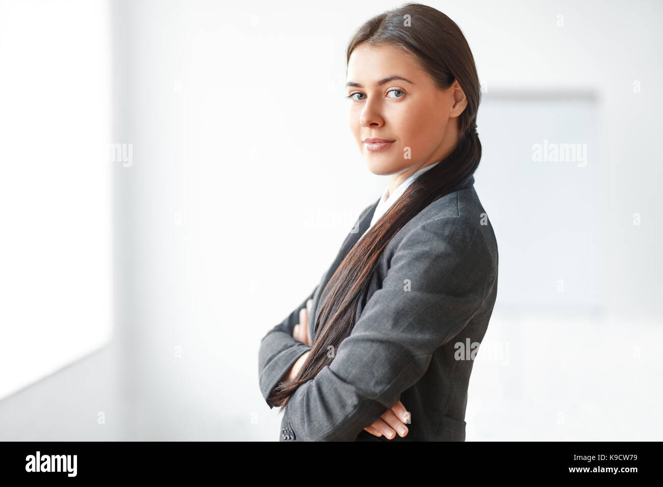 Portrait of young beautiful business woman in the office Stock Photo ...