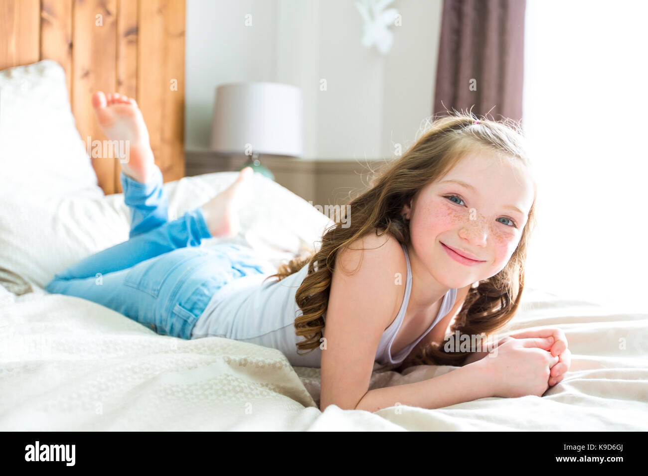 a girl lay on bed at home Stock Photo Alamy