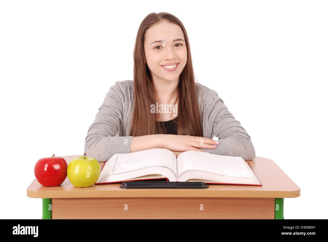 School girl sitting at a desk isolated on white Stock Photo - Alamy