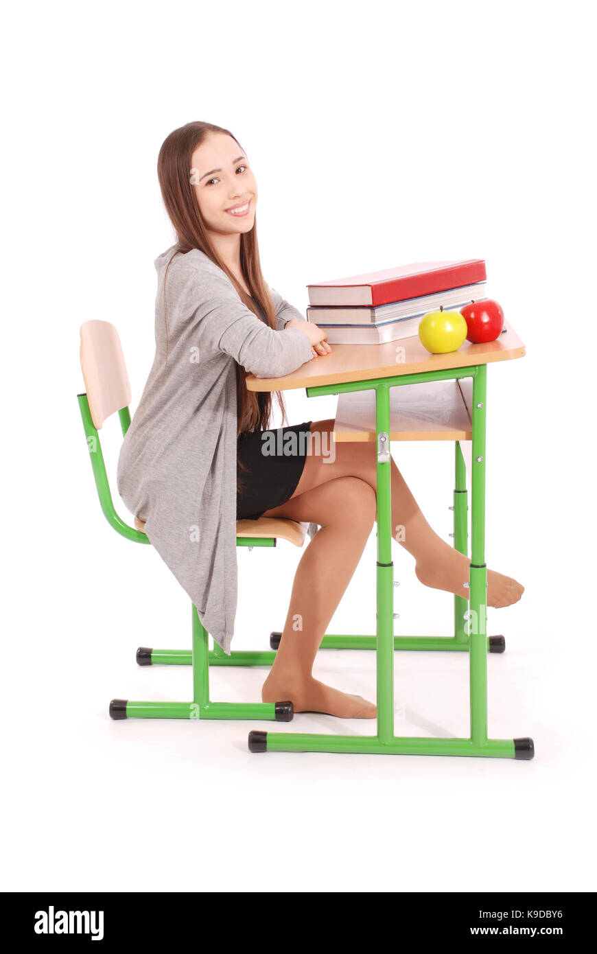 School girl sitting at a desk isolated on white Stock Photo - Alamy