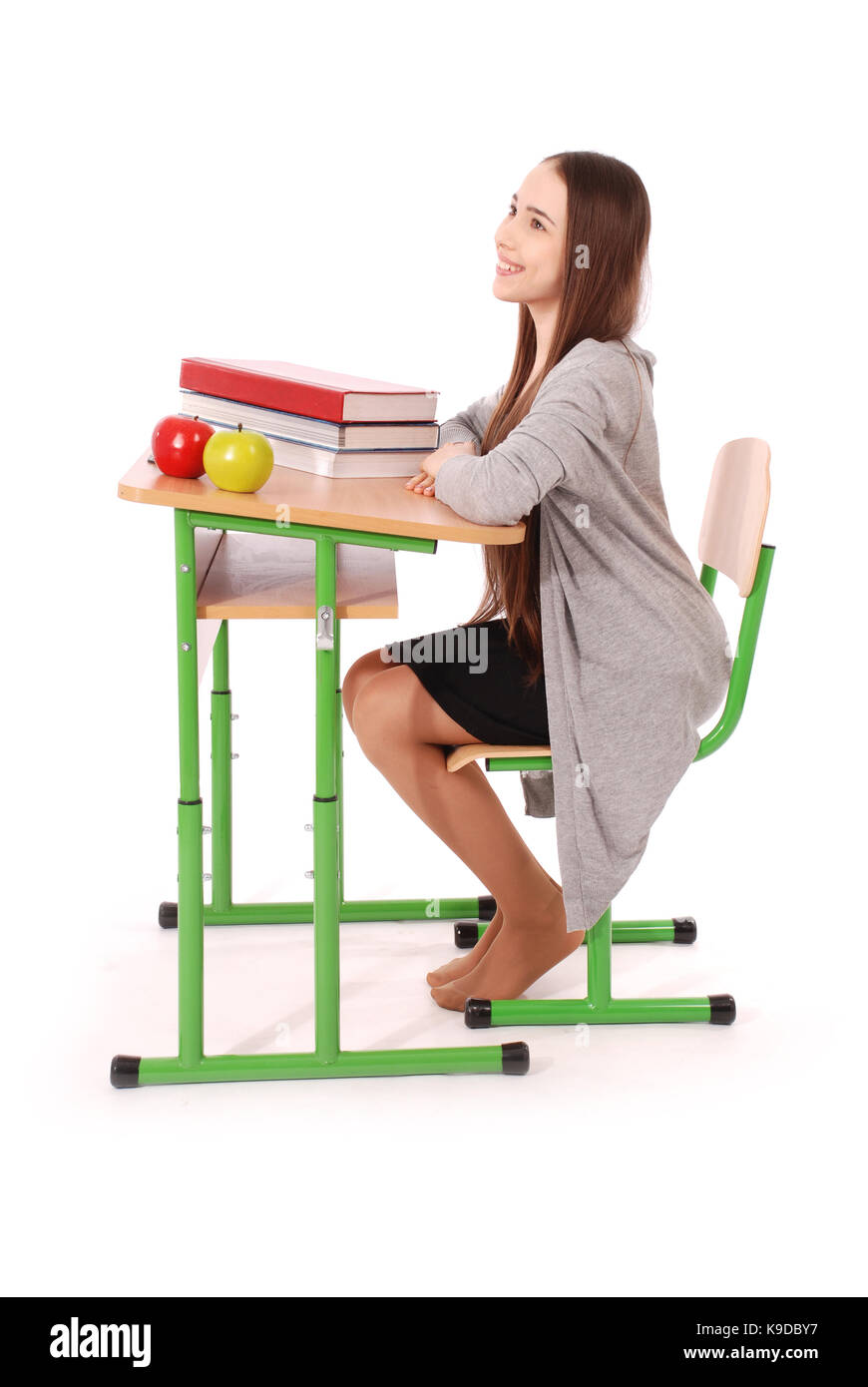 School girl sitting at a desk isolated on white Stock Photo - Alamy