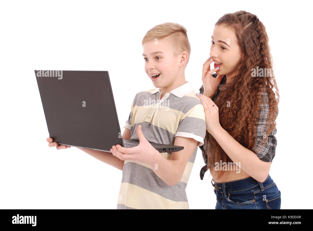 Boy and girl using a laptop isolated on white background Stock Photo