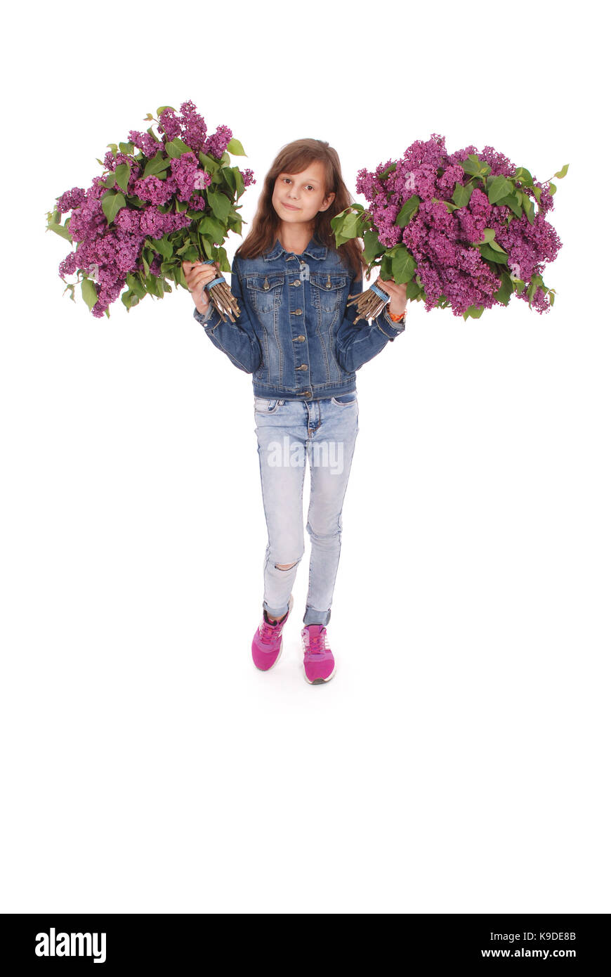 Teenage girl standing with lilac in both hands. Isolated on white ...