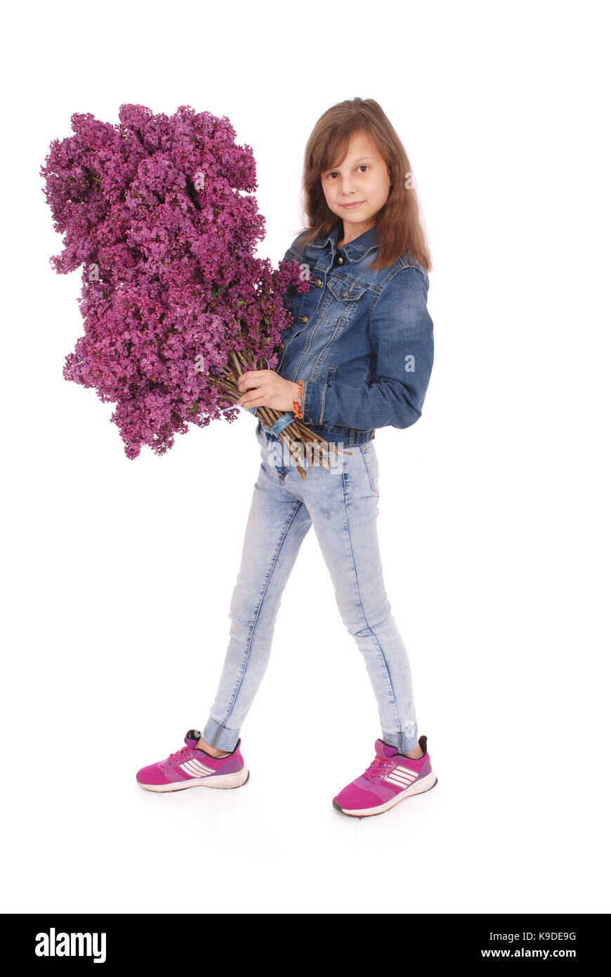 Teenage girl standing with lilac in both hands. Isolated on white ...