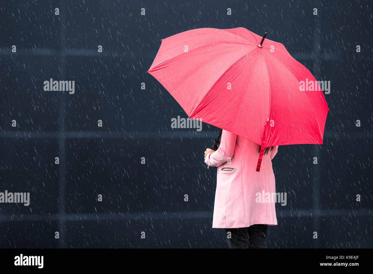Girl with red umbrella on rainy day Stock Photo - Alamy