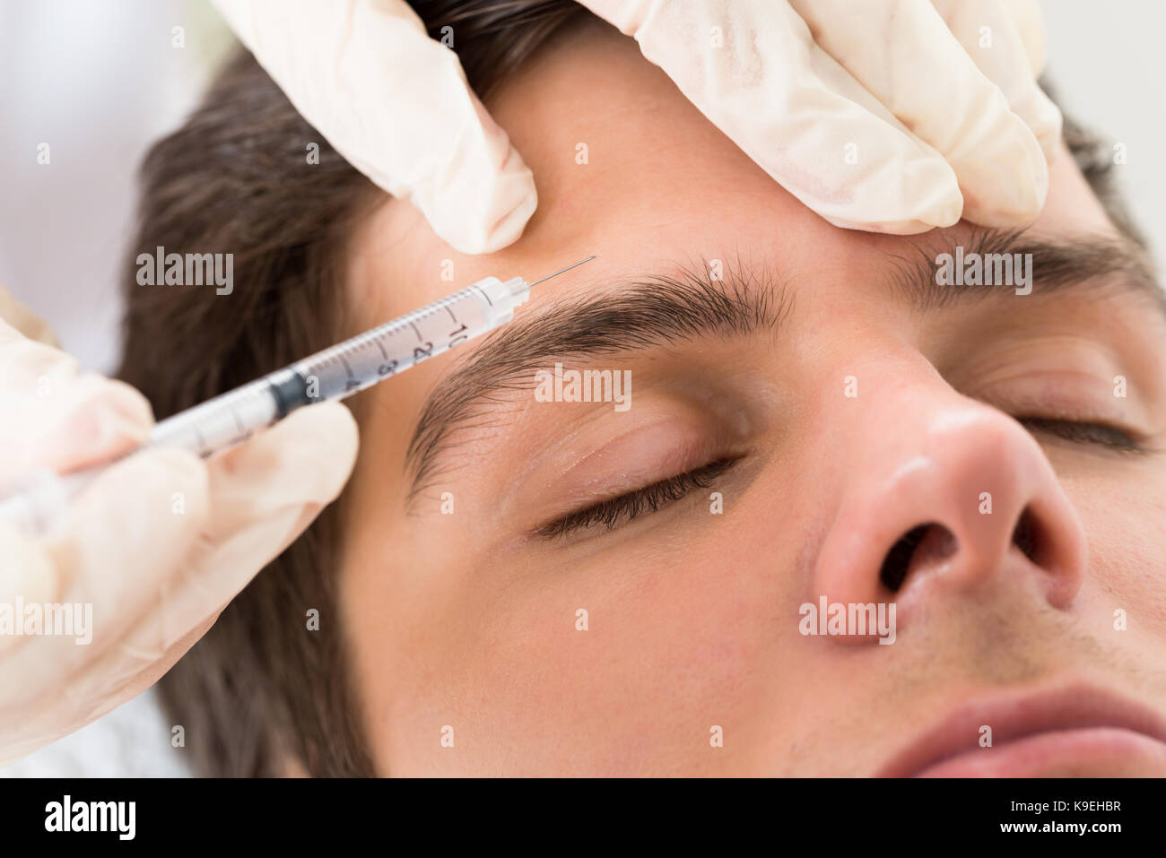 Young Man Having Botox Treatment At Beauty Clinic Stock Photo