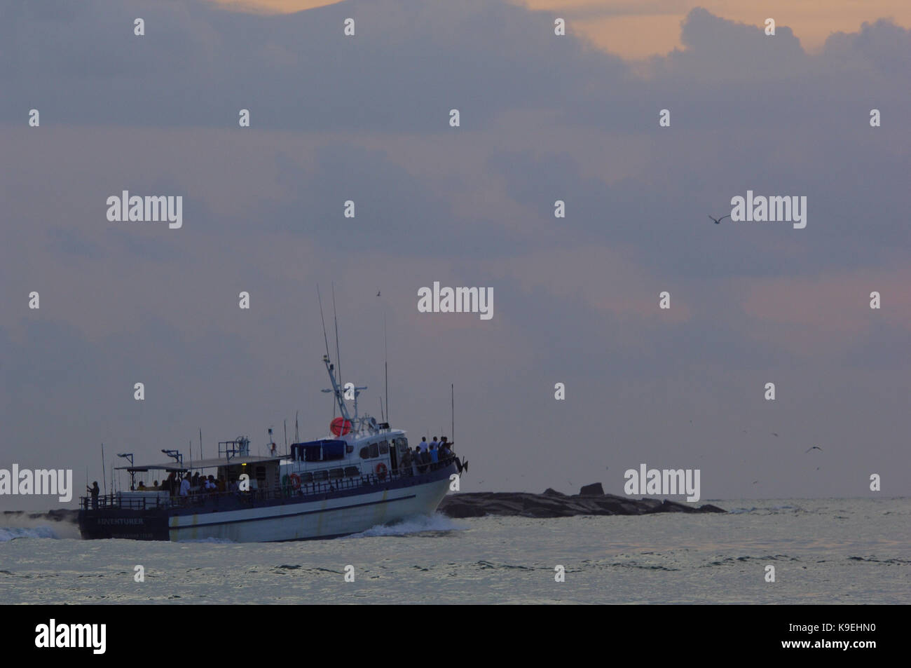 A charter party boat heads offshore for fishing near Port Aransas, Texas Stock Photo