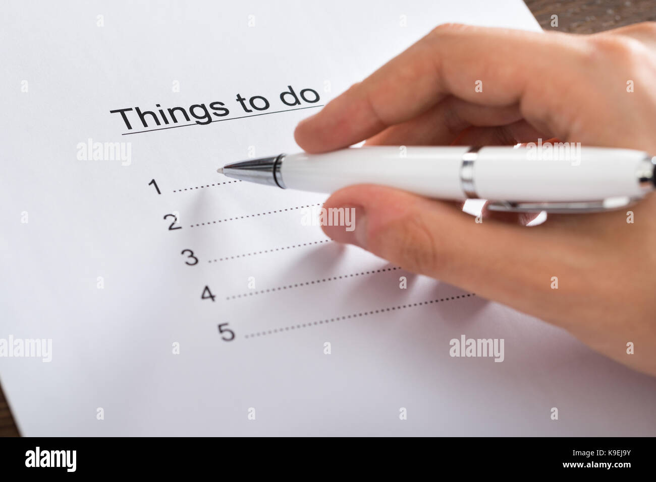 Close-up Of Person Hands Planning List Of Work To Do Stock Photo