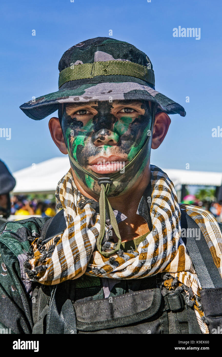 Head and shoulders portrait of a Special Unit Philippine National Policeman dressed in camo uniform and with full face paint in Puerto Princesa, Palaw Stock Photo