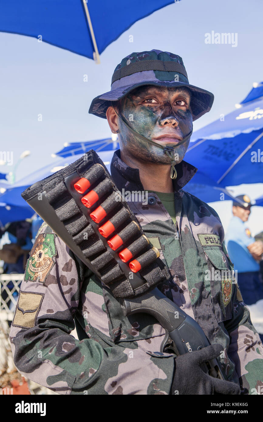 A member of the Philippine National Police Special Boat Unit (SBU) stands guard in Puerto Princesa City, Palawan Island, Philippines, Southeast Asia. Stock Photo