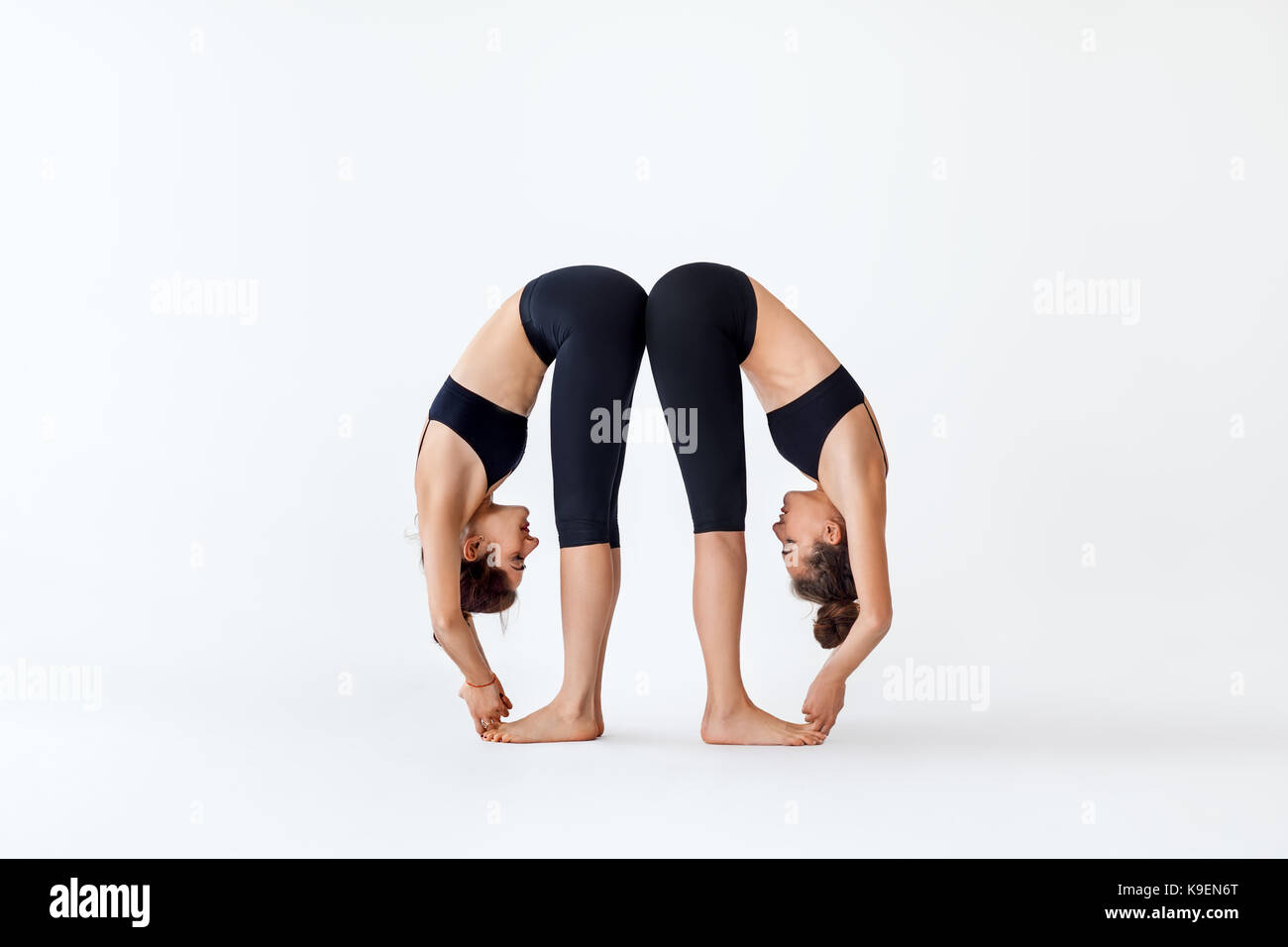 Woman doing yoga asana Uttanasana - standing forward bend Stock Photo by  ©DmitryRukhlenko 165379936