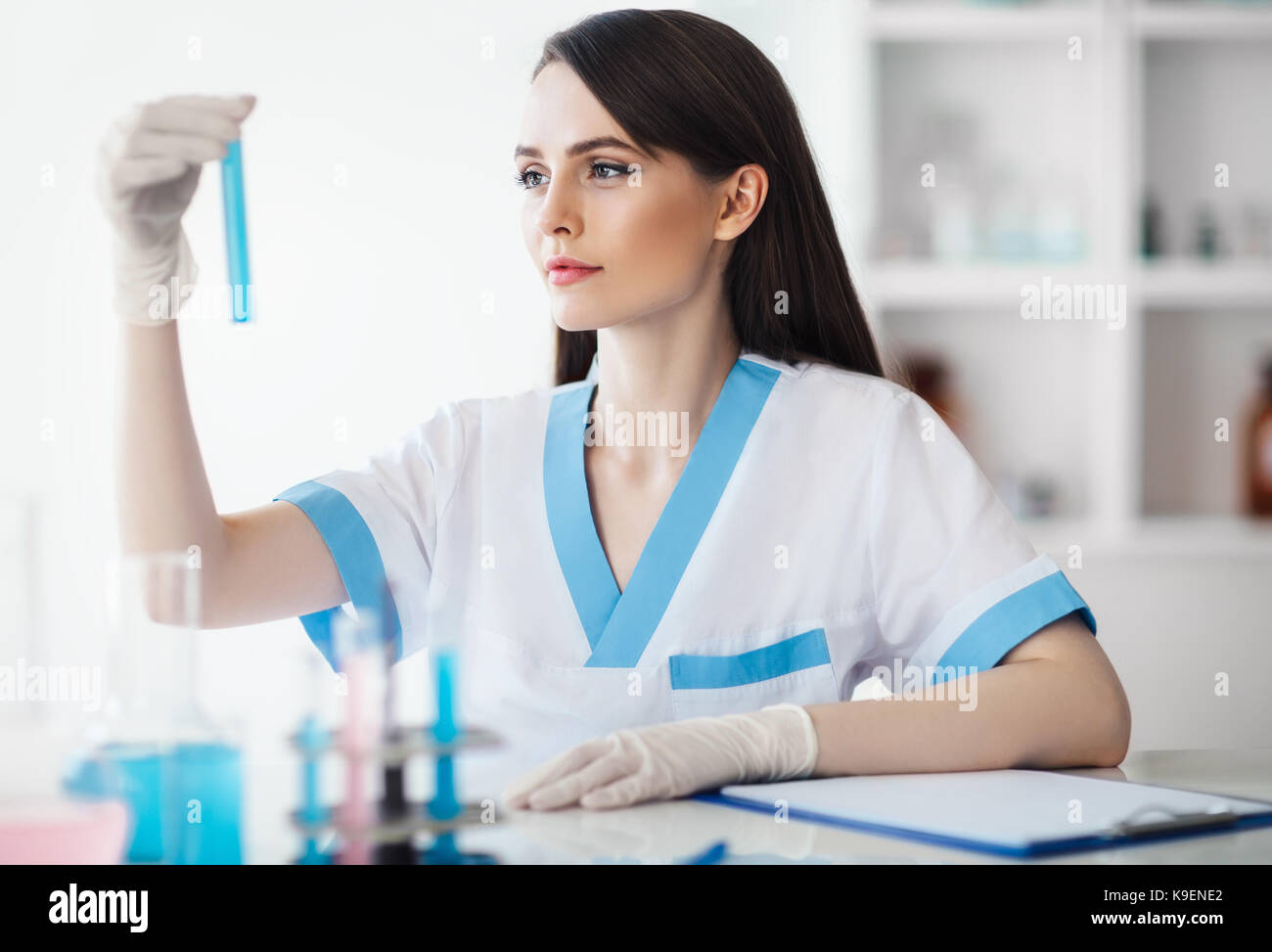 Young chemical female researcher holding flask in laboratory Stock ...