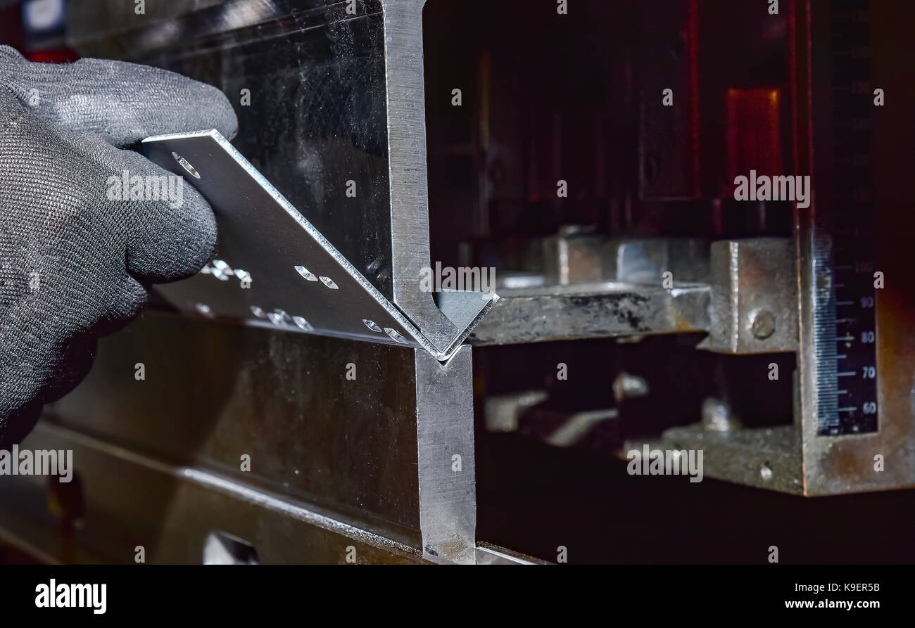 operator bending metal sheet by sheet bending machine bending of metal ...