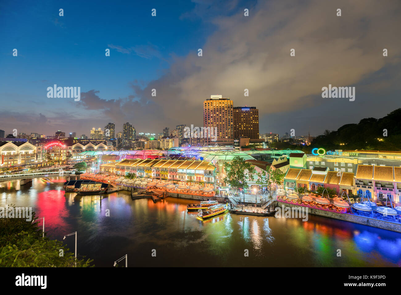 Colorful light building at night in Clarke Quay, Singapore. Clarke Quay, is a historical riverside quay in Singapore. Stock Photo