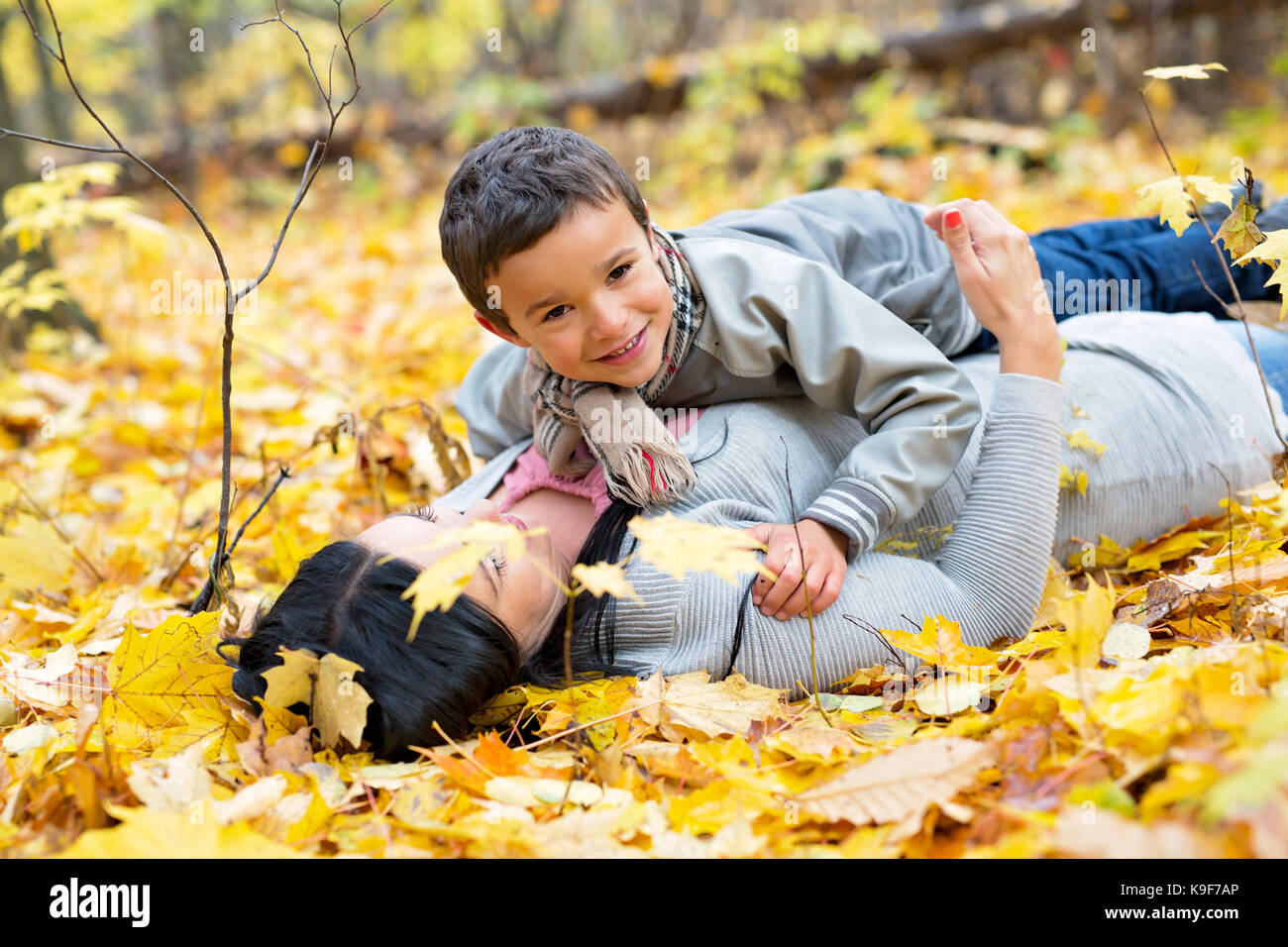 An Adorable little boy with his mother in autumn park Stock Photo - Alamy