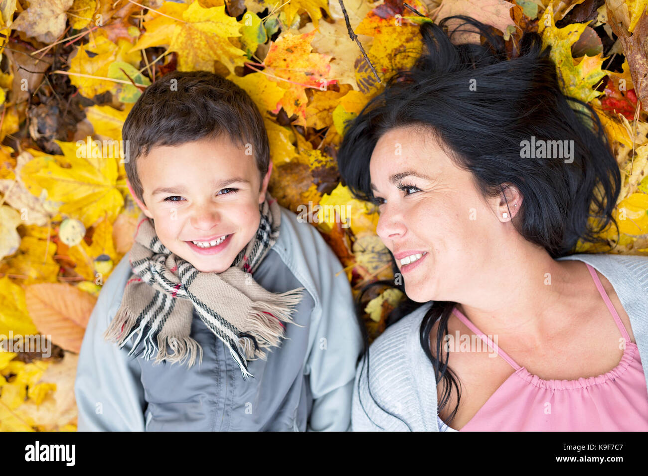 An Adorable little boy with his mother in autumn park Stock Photo - Alamy