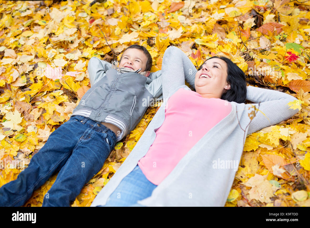 An Adorable little boy with his mother in autumn park Stock Photo - Alamy