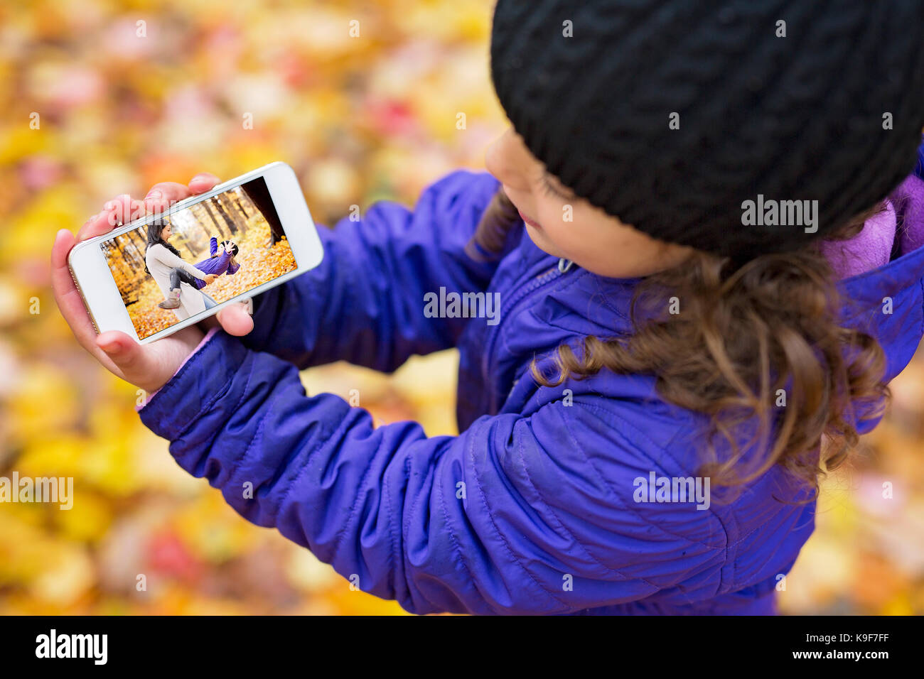 An Adorable little girl in a autumn forest Stock Photo - Alamy