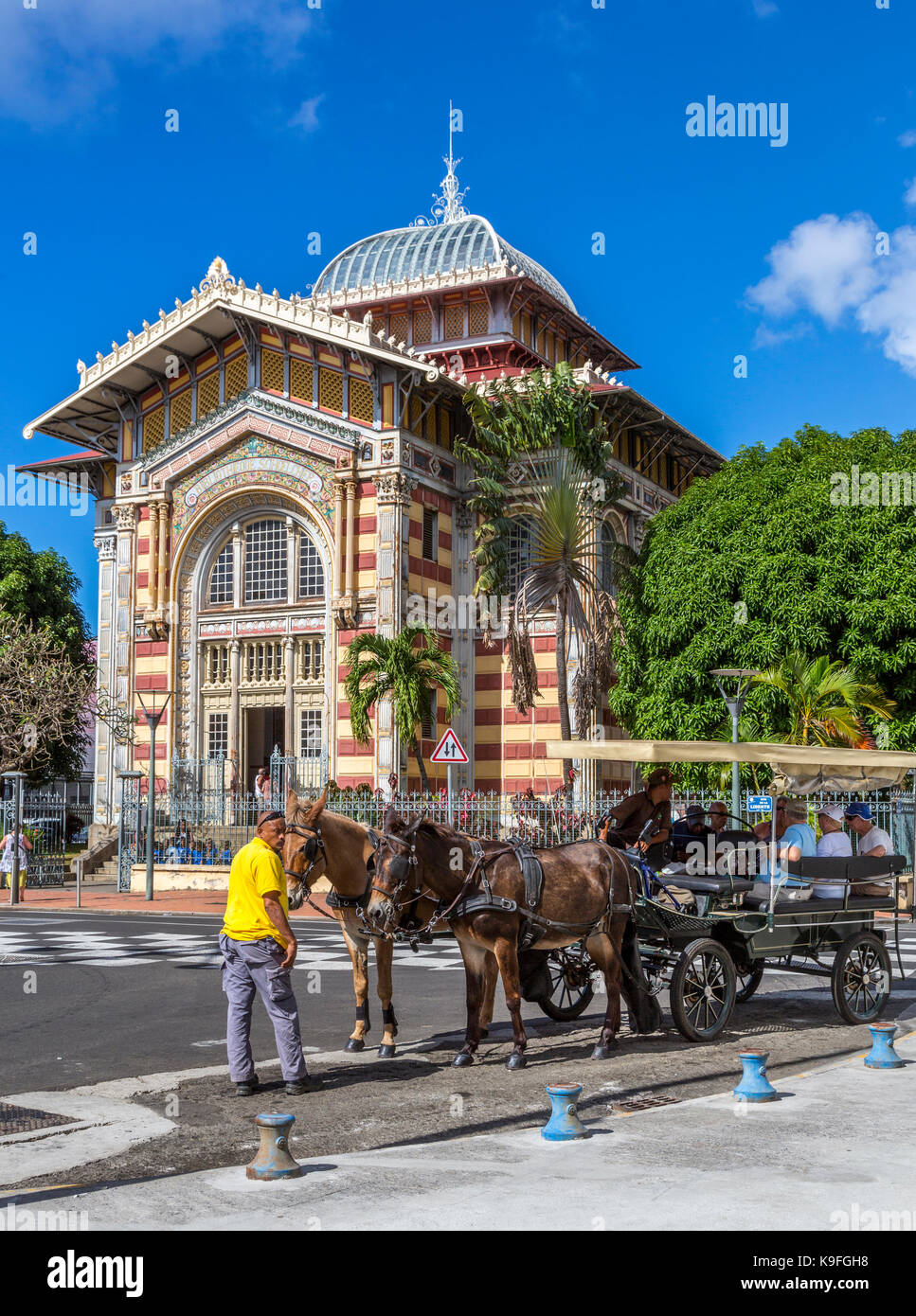 Fort-de-France, Martinique.  Tourists in Carriage  Passing the Victor Schoelcher Library Museum, Romanesque Architectural Style. Stock Photo