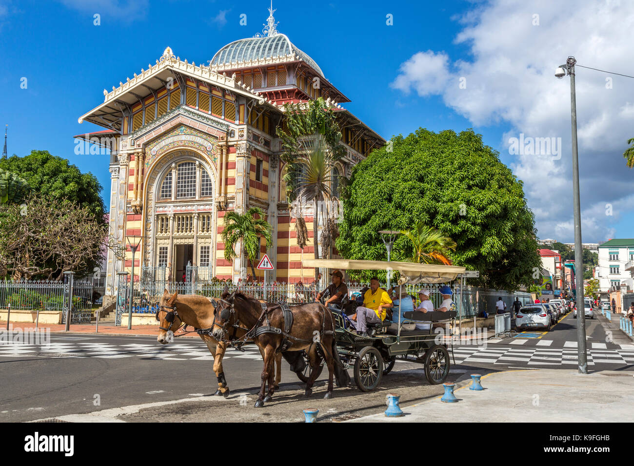 Fort-de-France, Martinique.  Tourists in Carriage  Passing the Victor Schoelcher Library Museum, Romanesque Architectural Style. Stock Photo