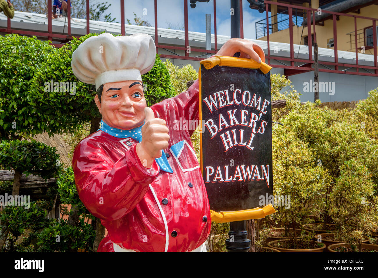 A life-size plastic pastry chef holds a sign welcoming visitors to Baker's Hill Tourist Attraction in Puerto Princesa, Palawan Island, Philippines. Stock Photo